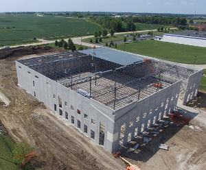 View of the warehouse being built, mostly metal and concrete.