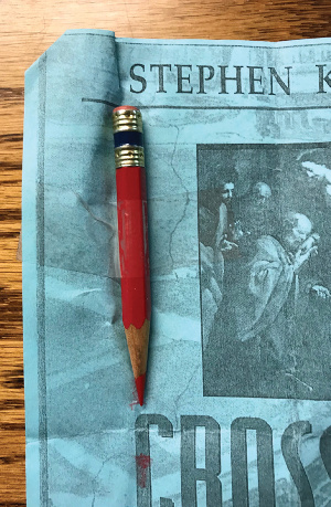 A red pencil, referenced in this letter, worn down to a nub.